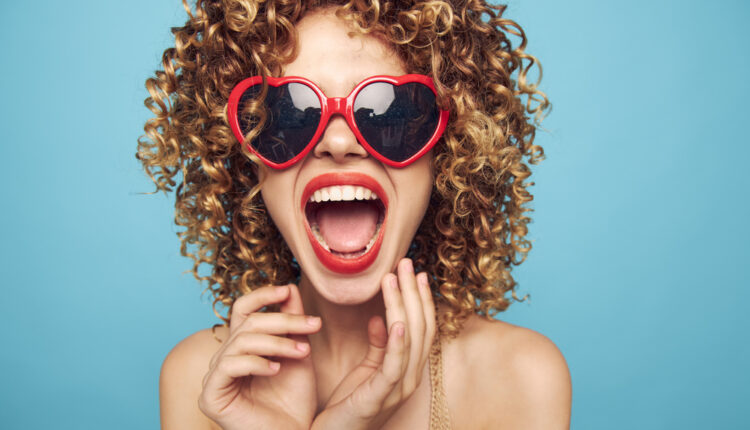Cheerful woman Wearing dark glasses red lips open mouth look forward